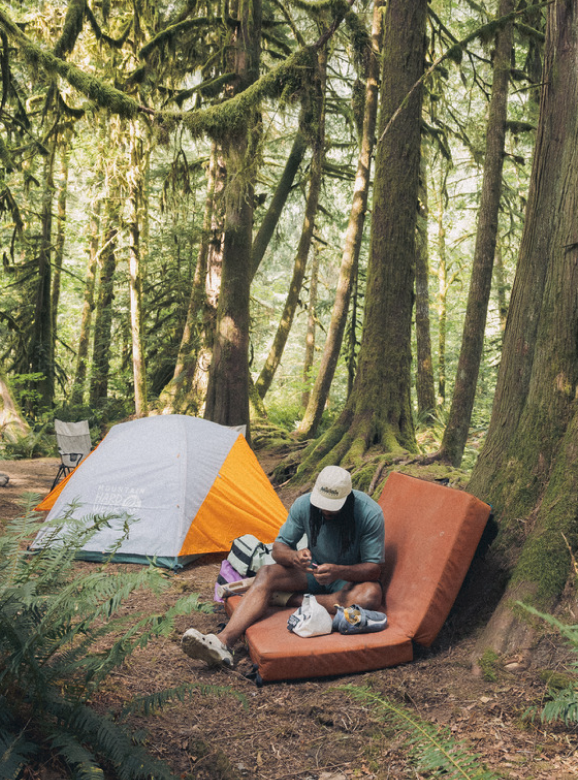 A climber sitting next to the Mineral King™ 2 All Season Tent