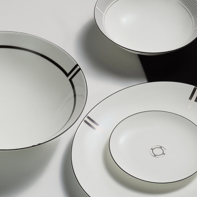 A zoomed crop of four tableware pieces from the new Vera Wang Luxe Graphite collection. A section of a salad bowl, a section of a serving plate and side plate, and a section from a cereal bowl are all visible. 