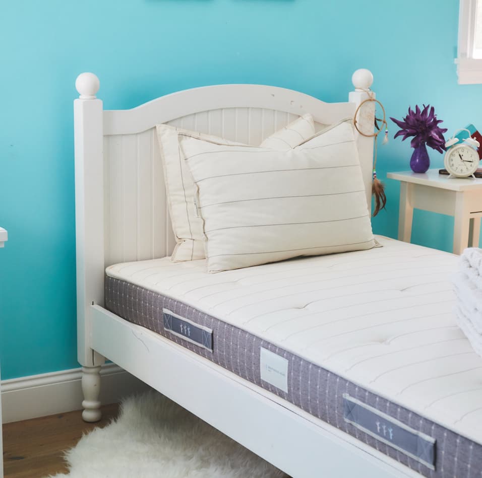 Juniper Mattress in a blue bedroom. 