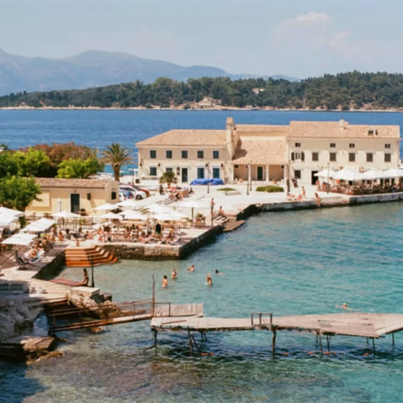 A sunny day at Faliraki Beach in Corfu Town, Greece, linking to BA High Life site.