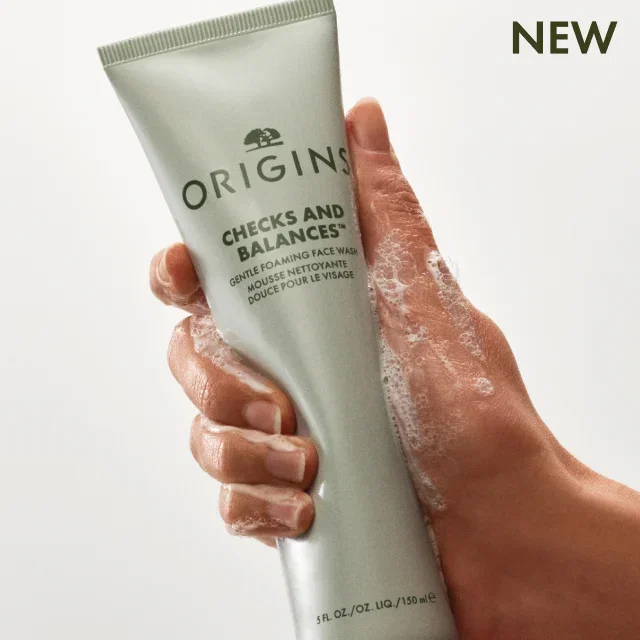 Hand squeezing a tube of  the new Checks and Balances™ Gentle Foaming Face Wash.