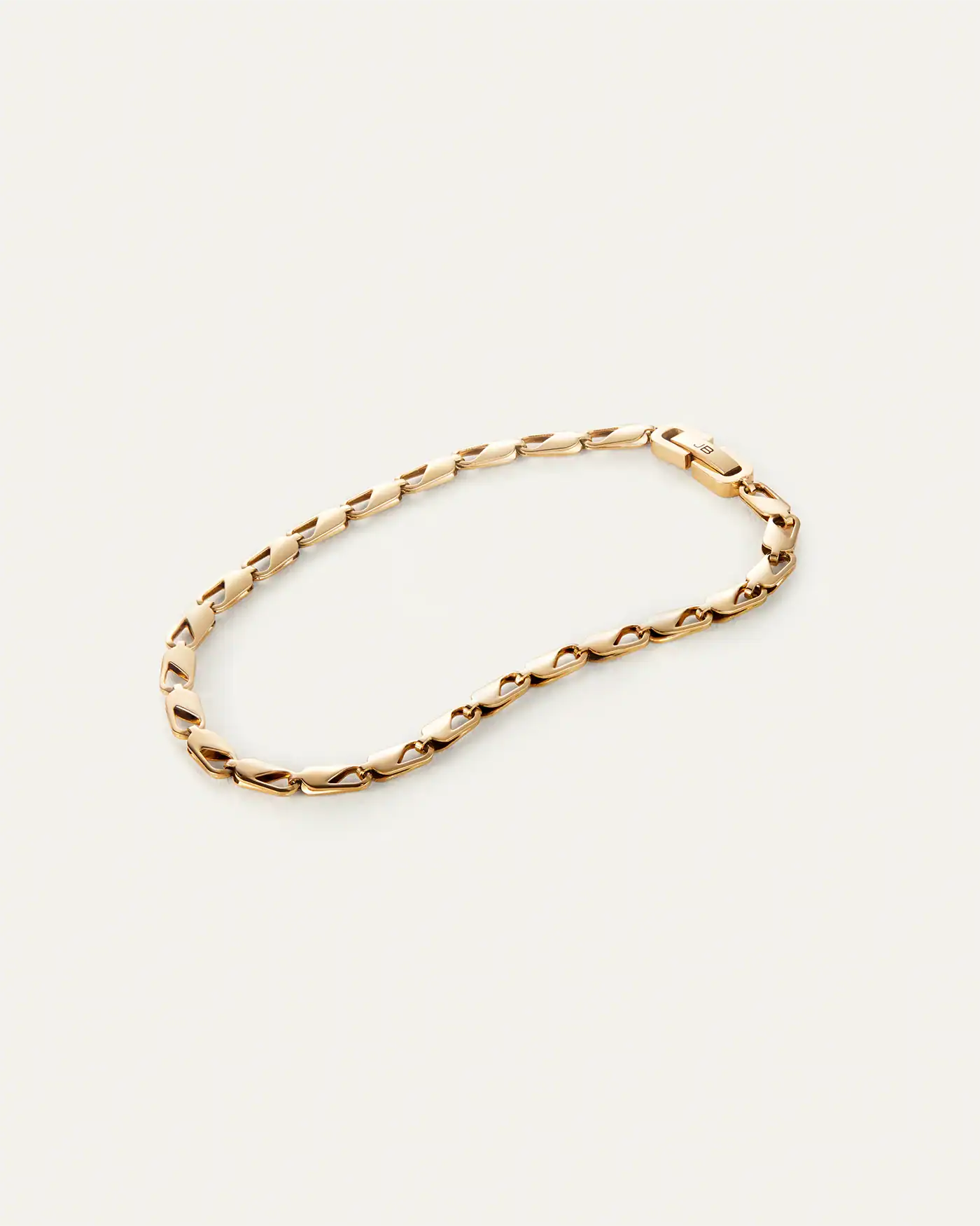 Small, oblong shapes featuring repetitive, asymmetrical cutouts make for a striking gold anklet. Each link is made of folded metal that adds subtle vo...