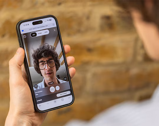 A man using a smartphone to virtually try on glasses