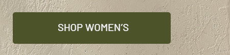 Shop women's button on green background with textured tan wall behind.