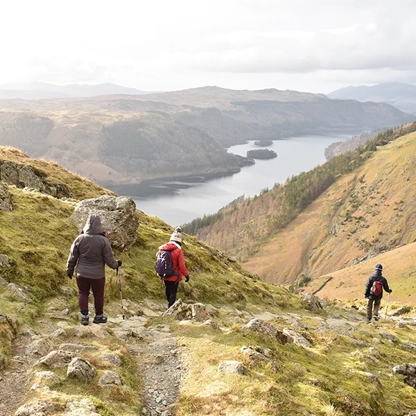 People hiking near a lake