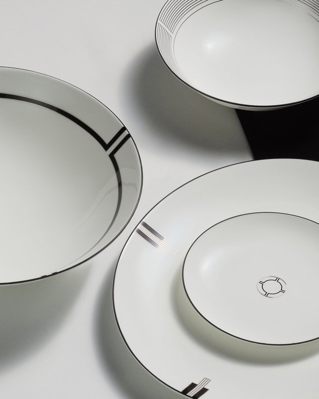 A zoomed crop of four tableware pieces from the new Vera Wang Luxe Graphite collection. A section of a salad bowl, a section of a serving plate and side plate, and a section from a cereal bowl are all visible. 