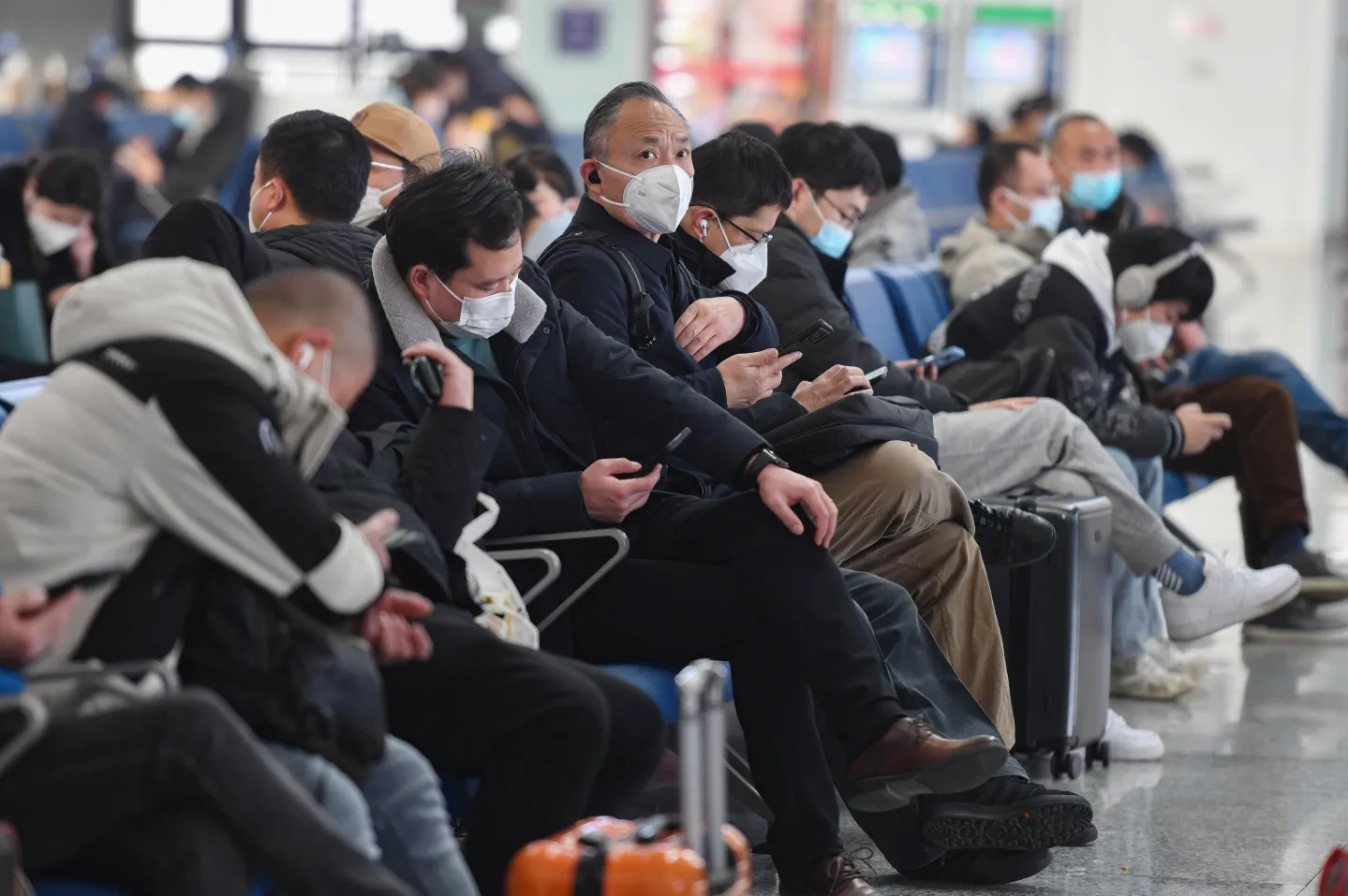 Passengers wearing face masks as a precaution against the spread of Covid-19 sit in the waiting room of a railway station, in Fuyang, China, in 2023. Sheldon Cooper/SOPA Images/LightRocket via Getty Images