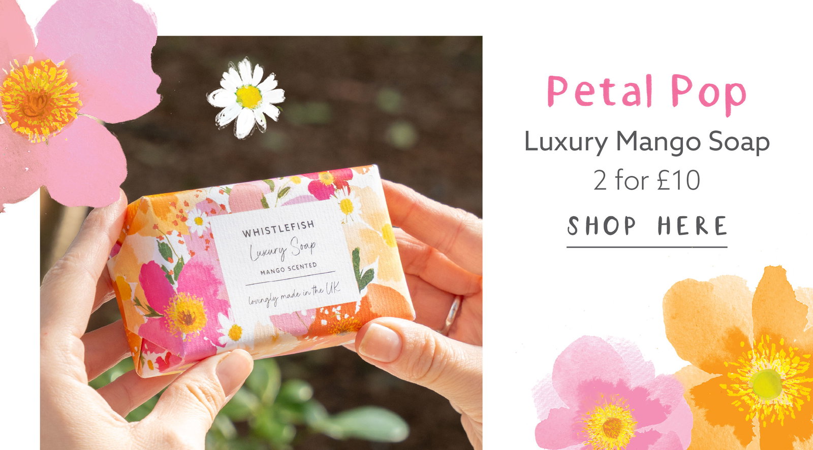 Hands holding Petal Pop luxury mango scented soap wrapped in bright floral packaging. Colourful floral soap gift made in the UK with a fresh mango fragrance.