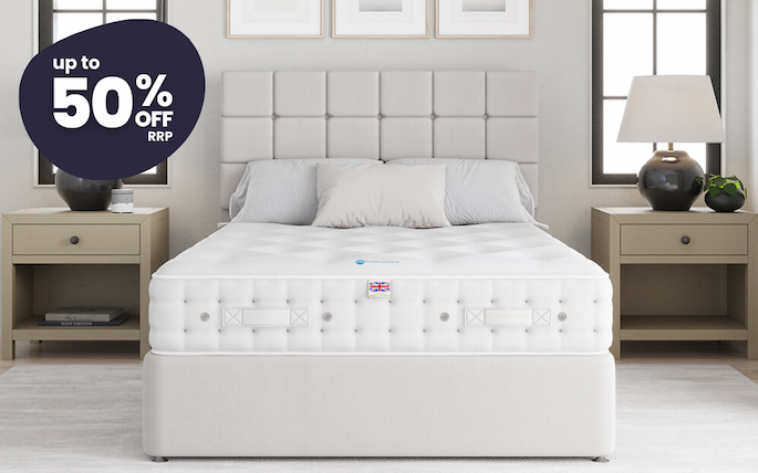 an image of a bed with a mattress and a night stand