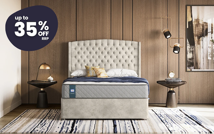an image of a bed with a blue cover and pillows