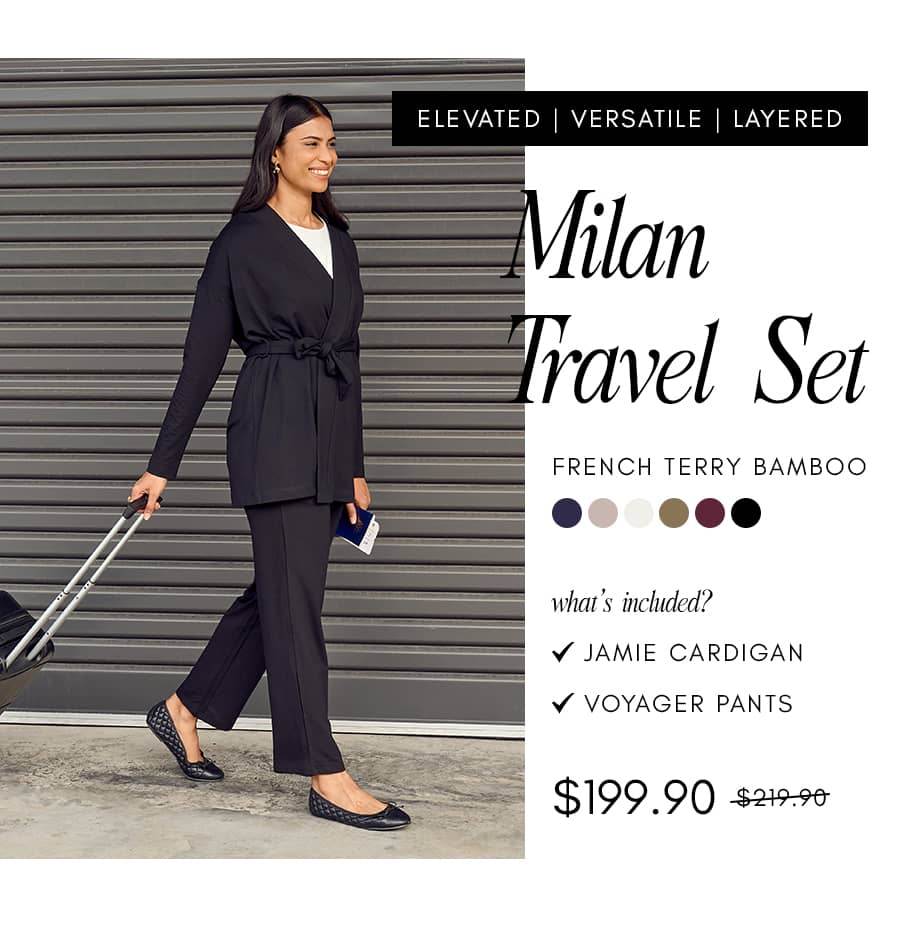 A woman in a black 'Milan Travel Set' consisting of a belted cardigan and pants walks with a suitcase and passport, with text reading 'ELEVATED | VERS...