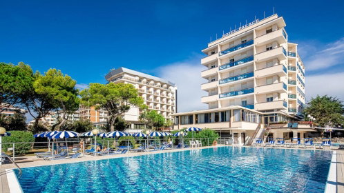 Hotel Außenansicht mit pool liegen und sonnenschirmen