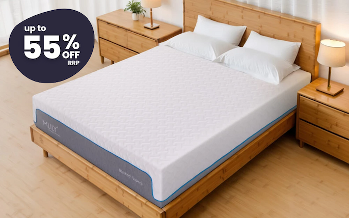 an image of a bed with a blue headboard and a white blanket