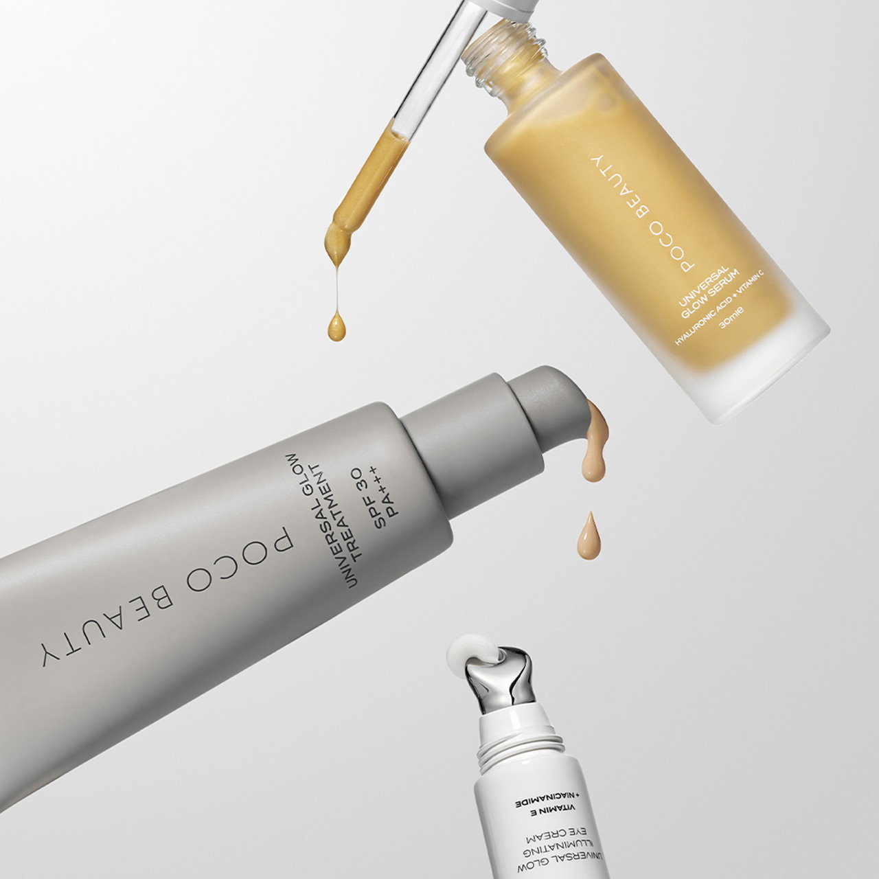 Assorted Poco Beauty skincare products with a dropper releasing liquid, featuring gray and white packaging.