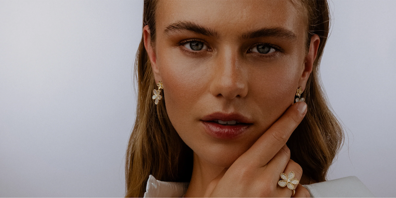 Woman wearing Roberto Coin earrings and ring