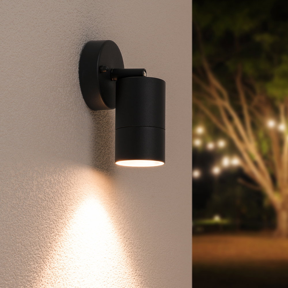 Lago wall light with an adjustable arm on a white wall, featuring a warm white light source 
