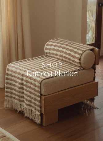 Brown and cream striped blanket draped on a chair