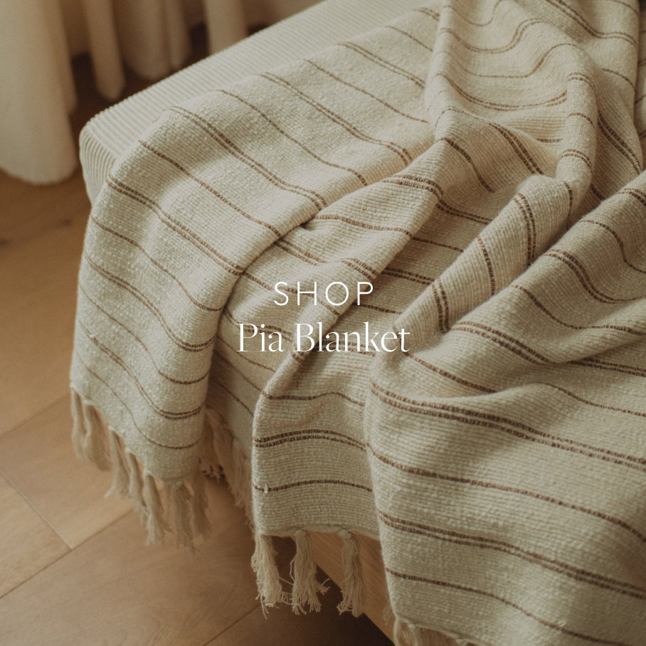 Detail of a beige blanket with brown stripes on a chair