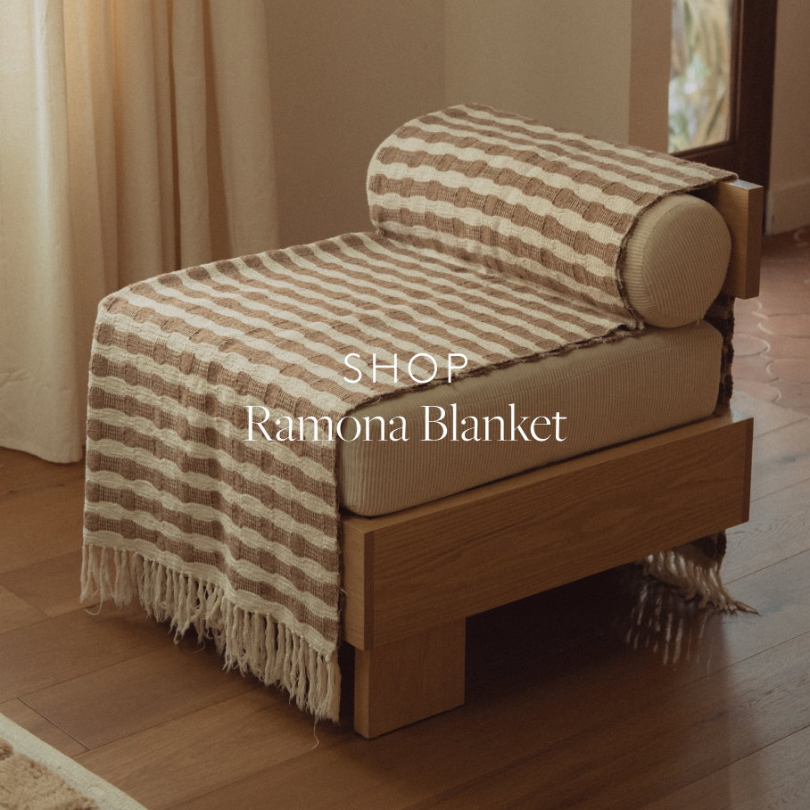 Brown and cream striped blanket draped on a chair