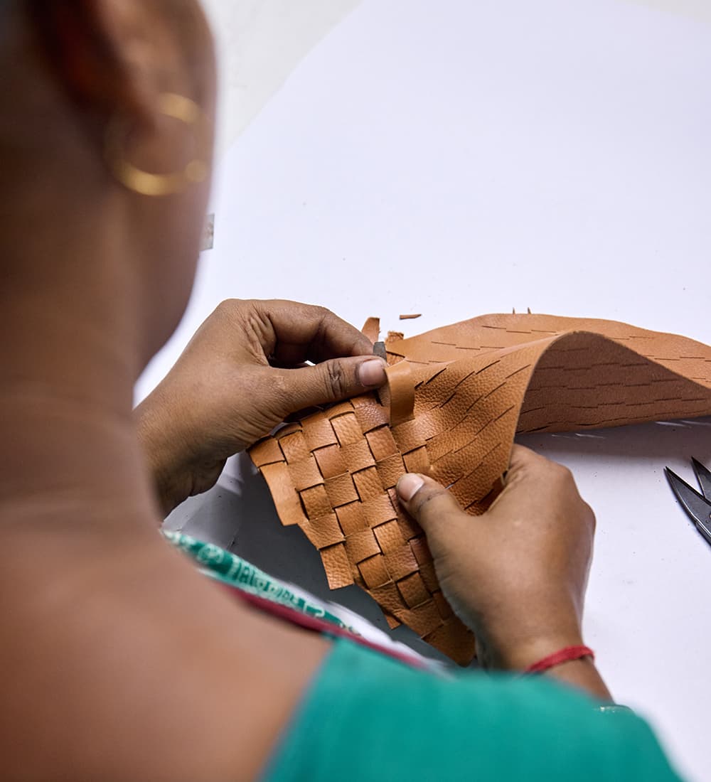 Woman weaving leather