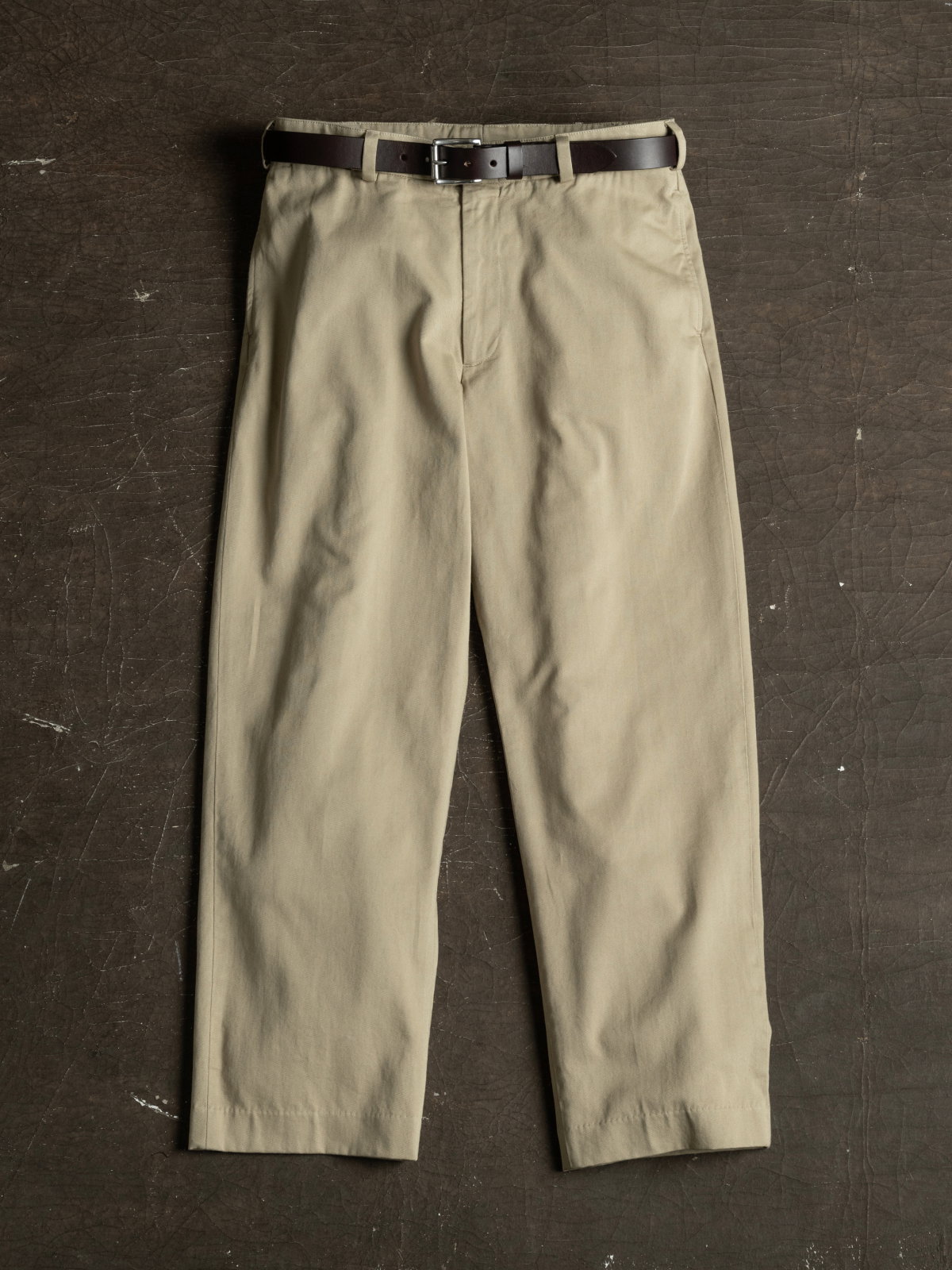 A full image of Bills Khakis M1 Original Twill Khakis laying on an industrial surface