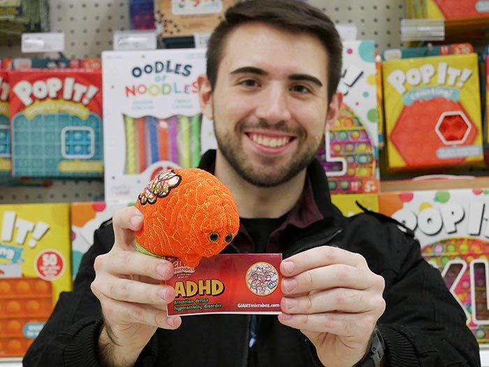Guy holding ADHD plush