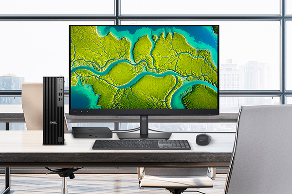 A Dell desktop computer, monitor, hub, wireless keyboard and mouse on an office desk.