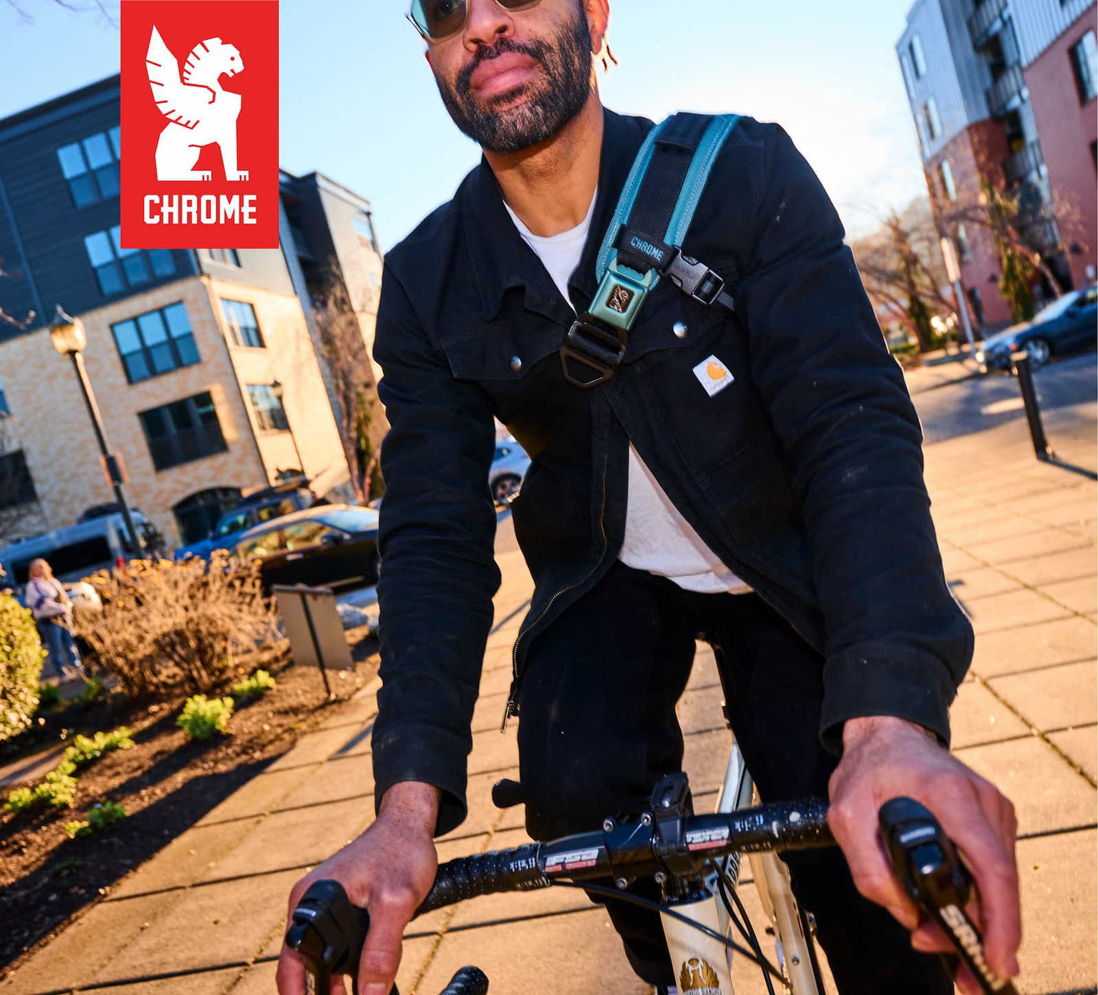 Kadet Max Sling in Steel Blue commuting on a man riding a bike