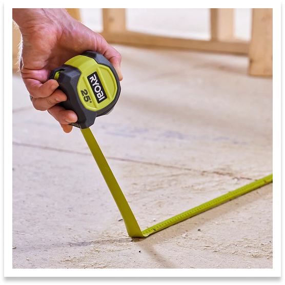 RYOBI tape measure being used to measure floor. 