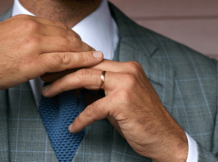 Man in a suit wearing a solid gold wedding band