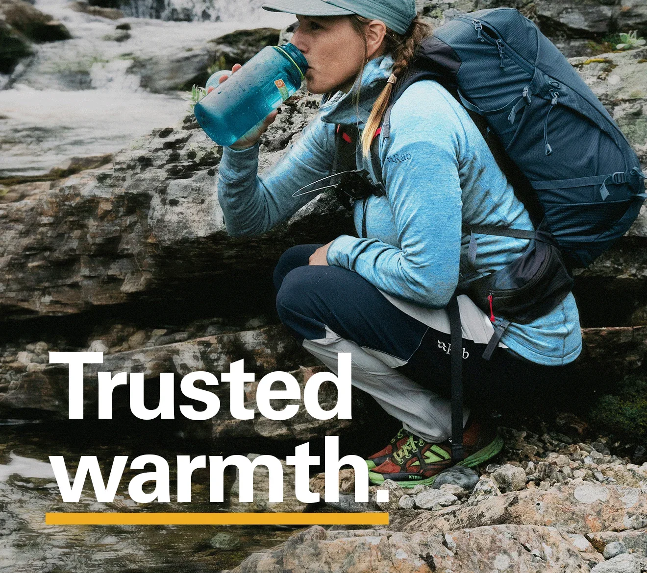 'Trusted Warmth' Copy displayed over the image of a woman having a drink while mid trail.