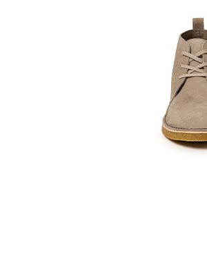 Partial image of a chukka boot in tan suede