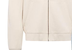 A partial slice of a light cream colored hoodie
