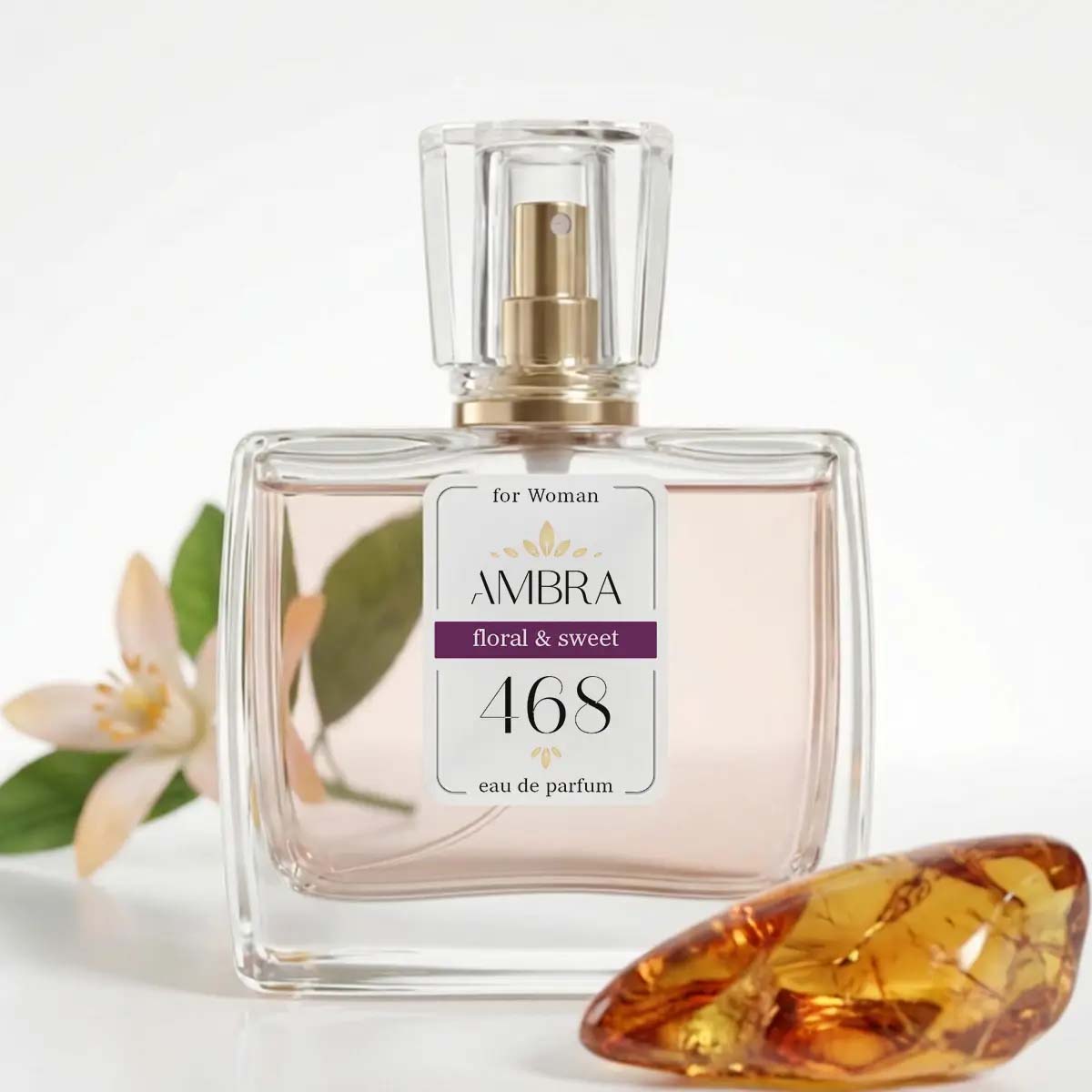 Glass perfume bottle labelled AMBRA 468 floral & sweet eau de parfum for women, pale pink liquid with jasmine blossom and amber stone