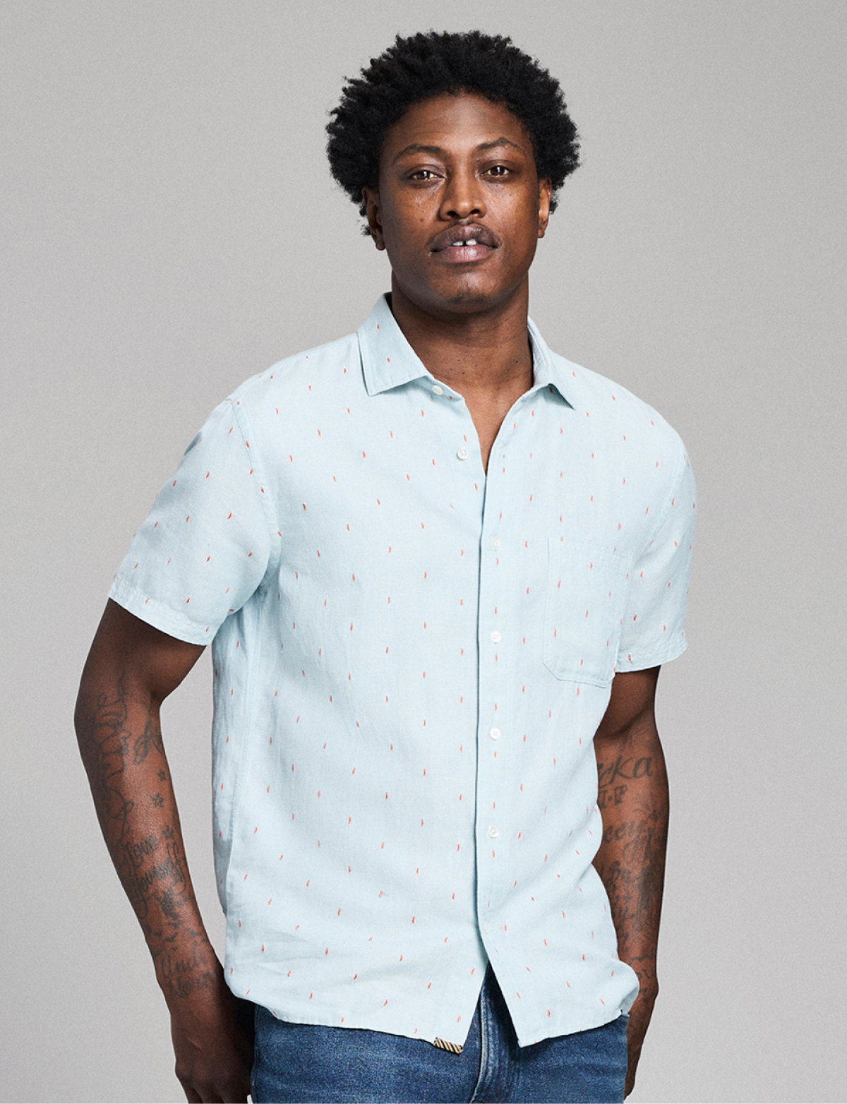 Model wears a short sleeve Billy Reid shirt.