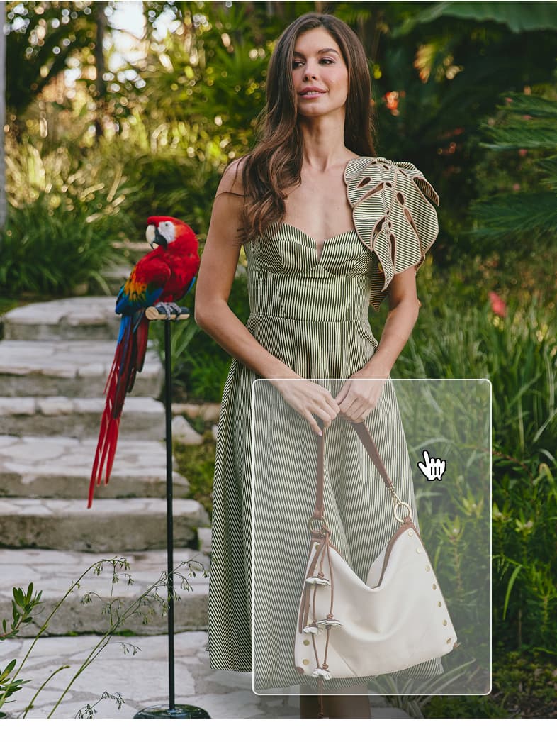 Model in green dress in tropical garden with kyle-lrg-tote-west-end-antique-gold