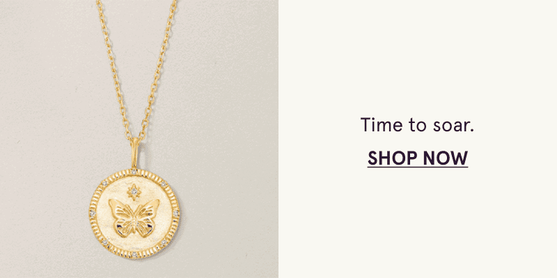 A gold medallion pendant with a butterfly design. Time to soar. Click here to shop now