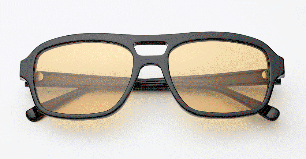 GIF: close-up of the acetate aviator sunglasses in black with tinted lenses over a grey background