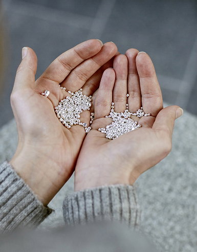 Open hands holding Pandora recycled silver
