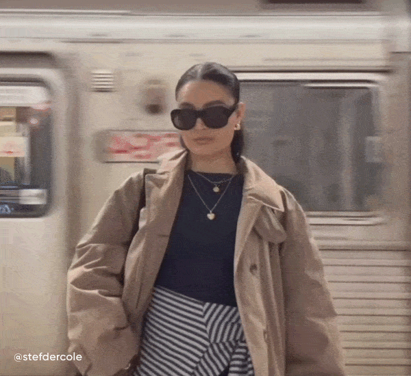 Female standing in front of moving train wearing the paris sunglasses