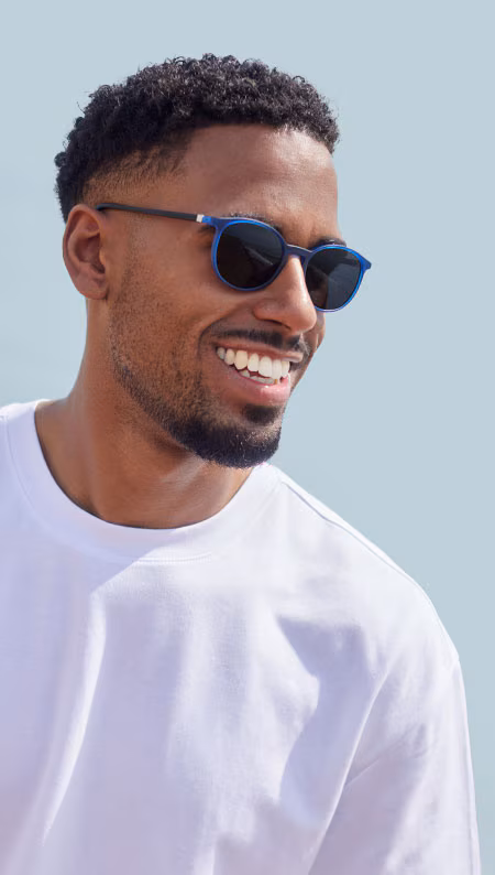 Smiling man in dark sunglasses with blue frames