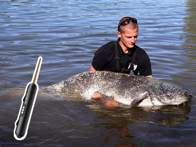 Darnell holding a huge catfish by the river, with a Smart Bait Pro displayed in the foreground. Customer shares excitement about catching fish with the product.