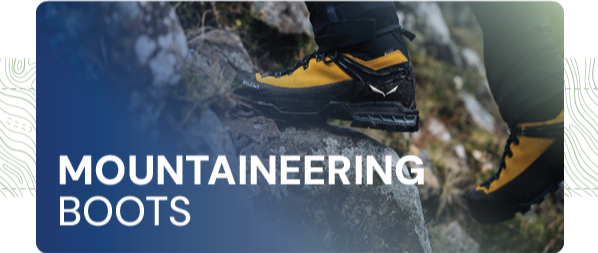 MOUNTAINEERING BOOTS: A man scrambles on the rocks, wearing Salewa Men's Ortles Ascent Mid GORE-TEX Mountaineering Boots in Yellow. 