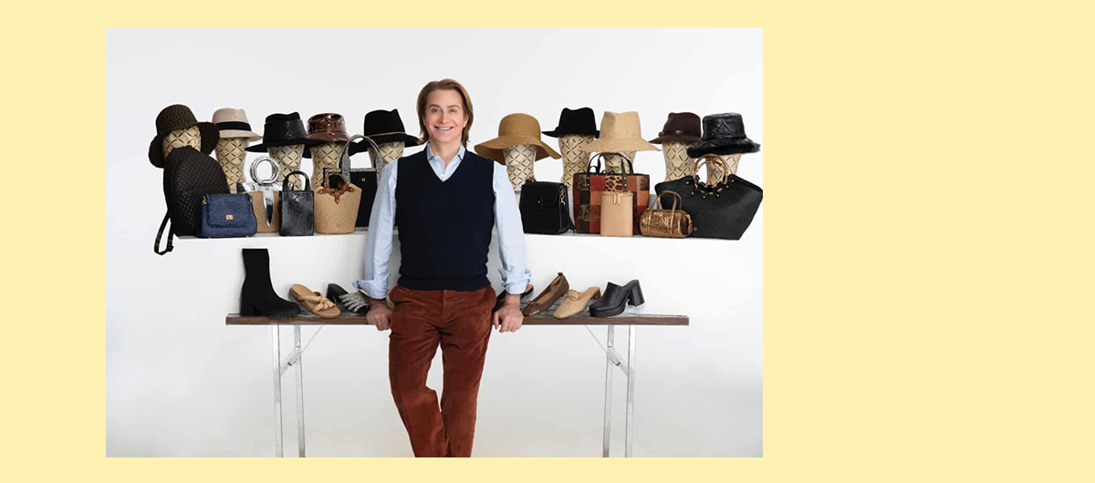 Eric Javits standing in front of a selection of his designs.