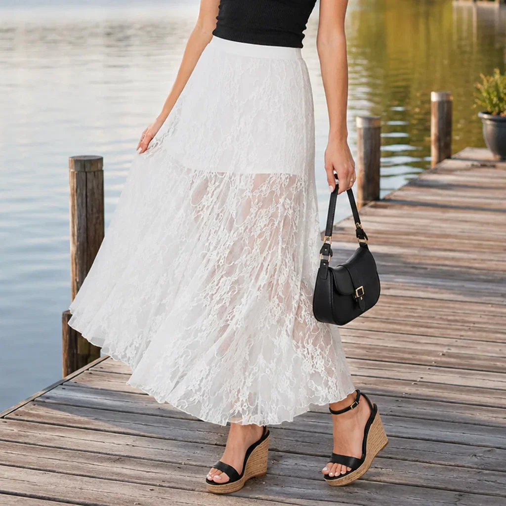 Woman wearing white lace midi skirt with black top, black shoulder bag, and cork wedge sandals on wooden dock.