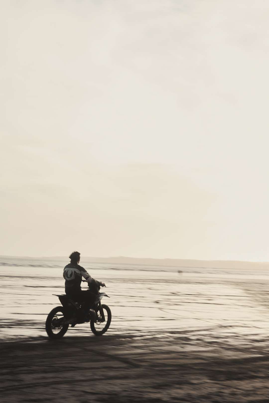 Model riding the Represent x Belstaff motorcross bike wearing the Leather Race Jacket