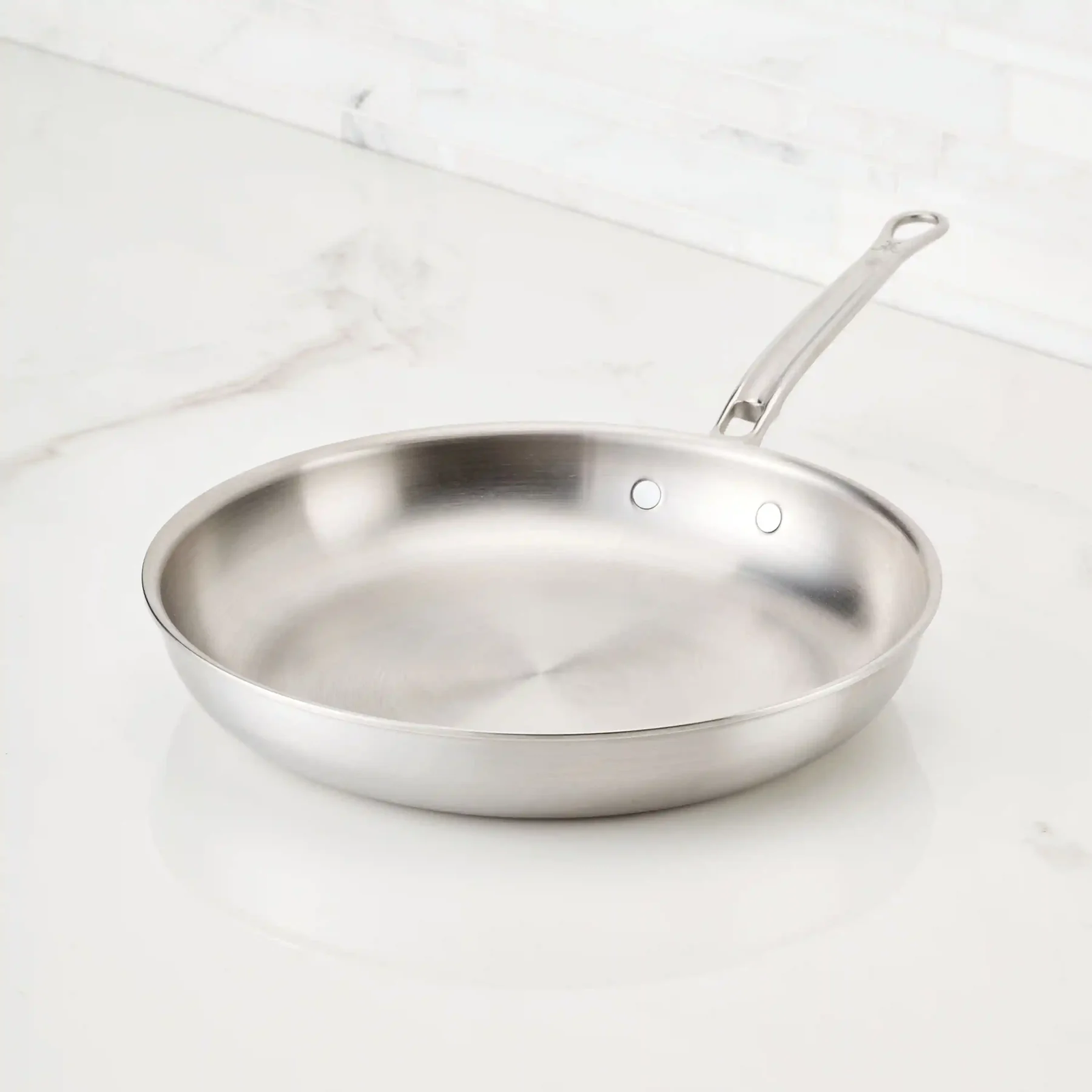 IMG: Thomas Keller Commercial Clad Stainless Steel Skillet on marble countertop