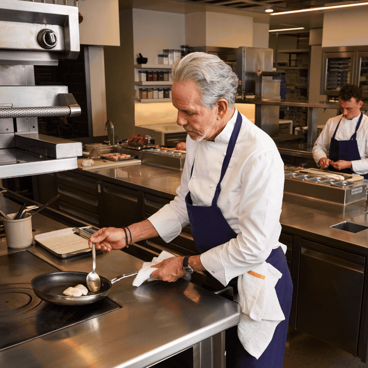 IMG: Chef Thomas Keller in the kitchen with Hestan cookware in front