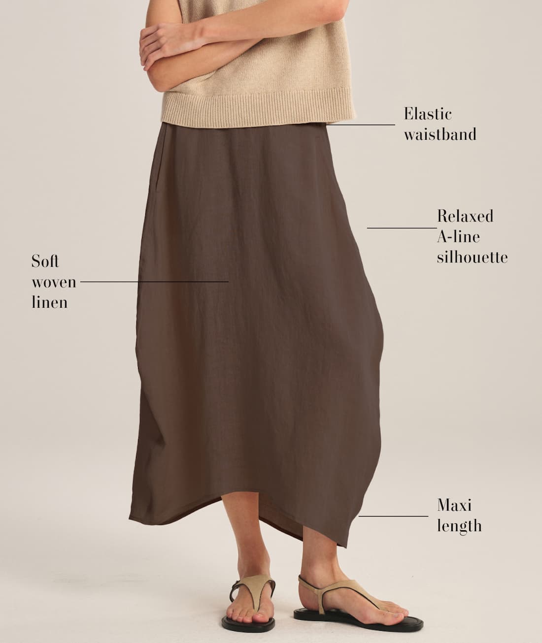Model wearing Fae Skirt in willow. Product details read: Soft woven linen, elastic waistband, relaxed a-line silhouette, maxi length.
