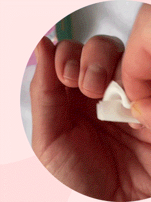 Close-up view of fingertips holding a white nail file against pink background